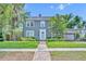 Charming two-story home featuring a well-manicured lawn, brick walkway, and a welcoming light blue front door at 216 E Vanderbilt St, Orlando, FL 32804