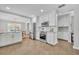 Open kitchen featuring white cabinets, stainless steel appliances, a subway tile backsplash, and an adjacent dining area at 216 E Vanderbilt St, Orlando, FL 32804