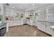 Well-lit kitchen with white cabinets, subway tile backsplash, stainless steel appliances, and tile flooring at 216 E Vanderbilt St, Orlando, FL 32804