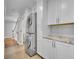 Convenient laundry room with modern appliances, cabinets, and stone countertops at 216 E Vanderbilt St, Orlando, FL 32804