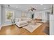 Bright living room with hardwood floors, modern furnishings, a ceiling fan, and ample natural light at 216 E Vanderbilt St, Orlando, FL 32804