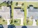 Aerial view of a single Gathering home with yellow boundary, landscaping, and a paved driveway at 2192 Kerwood Loop, The Villages, FL 32162