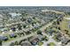 Get a birds eye view of a beautiful community with lush greenery and a sprawling golf course in the distance at 2192 Kerwood Loop, The Villages, FL 32162