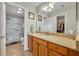 Bathroom featuring a walk-in shower and a neutral-toned vanity with a large mirror at 2192 Kerwood Loop, The Villages, FL 32162