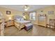 Bright bedroom with wooden floors, complemented by wood furnishings and natural light at 2192 Kerwood Loop, The Villages, FL 32162