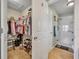 Organized walk-in closet with ample shelving and clothing racks, adjacent to a bathroom at 2192 Kerwood Loop, The Villages, FL 32162