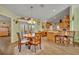 Dining area open to the kitchen with a view of the patio, perfect for entertaining at 2192 Kerwood Loop, The Villages, FL 32162