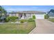 Charming single-story home featuring manicured landscaping and a two-car garage at 2192 Kerwood Loop, The Villages, FL 32162