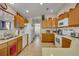 Bright kitchen featuring ample cabinet space, modern appliances, and updated countertops at 2192 Kerwood Loop, The Villages, FL 32162