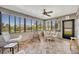 Enclosed sunroom with tiled floors, a ceiling fan, and panoramic views of the surrounding landscape at 2192 Kerwood Loop, The Villages, FL 32162