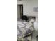 Inviting bedroom with a desk for work, a view into the hall and cozy patterned bedding at 2218 Abbey Rd, Winter Haven, FL 33880