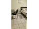 Bedroom with tiled floor, a desk, and a comfortable bed with stylish patterned bedding and accent rug at 2218 Abbey Rd, Winter Haven, FL 33880