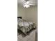 Calm bedroom featuring tile flooring, a ceiling fan, and a comfortable bed with stylish patterned bedding at 2218 Abbey Rd, Winter Haven, FL 33880