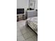 Serene bedroom featuring ceramic tile, a dresser with mirror, and tv, all in a calm color palette at 2218 Abbey Rd, Winter Haven, FL 33880