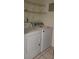 Functional laundry room featuring a washer, dryer, and wire shelving for organized storage solutions at 2218 Abbey Rd, Winter Haven, FL 33880