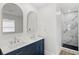 Bathroom featuring double sinks with elegant faucets and a marble tiled shower at 2314 Meadowbrook St, Kissimmee, FL 34744