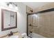 Bathroom featuring a vanity mirror and a shower tub with beige tiling and black accents at 2314 Meadowbrook St, Kissimmee, FL 34744