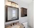 Bathroom with granite counters, traditional faucet, vanity mirror and dark wood accents at 2314 Meadowbrook St, Kissimmee, FL 34744