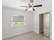 Bedroom featuring neutral paint, tile floors, and closet with mirrored doors at 2314 Meadowbrook St, Kissimmee, FL 34744