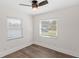 Bright bedroom with neutral paint, ceiling fan, luxury vinyl floors, and large windows at 2314 Meadowbrook St, Kissimmee, FL 34744
