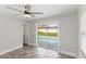 Bright bedroom with tile floors, sliding glass doors to the pool, and large windows at 2314 Meadowbrook St, Kissimmee, FL 34744