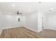 Bright bedroom with vinyl floors, ceiling fan, recessed lights, and fresh paint at 2314 Meadowbrook St, Kissimmee, FL 34744