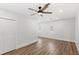 Bright bedroom featuring vinyl floors, neutral paint, ceiling fan, closet, and windows at 2314 Meadowbrook St, Kissimmee, FL 34744