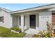 Close-up of home exterior featuring a textured facade, well-kept lawn, and charming front entry at 2314 Meadowbrook St, Kissimmee, FL 34744