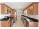 Updated kitchen featuring granite countertops, stainless steel appliances, and wood cabinetry at 2314 Meadowbrook St, Kissimmee, FL 34744