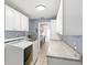 Well-equipped laundry area with granite countertops, cabinetry, and modern washer and dryer at 2314 Meadowbrook St, Kissimmee, FL 34744