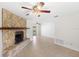 Spacious living room featuring tile flooring, stone fireplace, and access to the pool area at 2314 Meadowbrook St, Kissimmee, FL 34744
