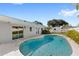 Backyard view of the Kidney shaped swimming pool, surrounded by patio and lush landscaping at 2314 Meadowbrook St, Kissimmee, FL 34744