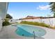 Backyard kidney shaped swimming pool with surrounding landscaping and fencing at 2314 Meadowbrook St, Kissimmee, FL 34744