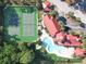 Aerial view showcasing tennis courts, pool, clubhouse, and landscaping at 232 Afton Sq # 201, Altamonte Springs, FL 32714