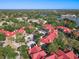An aerial view of a vibrant condo community features lush landscaping and a serene lake at 232 Afton Sq # 201, Altamonte Springs, FL 32714
