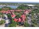 An aerial view captures a community of red-roofed condos nestled among mature trees and water views at 232 Afton Sq # 201, Altamonte Springs, FL 32714