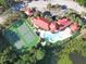 Overhead view showcasing tennis courts, pool, clubhouse, landscaping, and the nearby lake at 232 Afton Sq # 201, Altamonte Springs, FL 32714