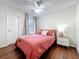 Bright bedroom with hardwood floors, large window, and stylish nightstand at 232 Afton Sq # 201, Altamonte Springs, FL 32714