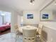 Cozy dining area with room for four, next to a bedroom, featuring a large mirror and neutral tones at 232 Afton Sq # 201, Altamonte Springs, FL 32714