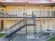 A condo building with private entrances on two floors, accessible by exterior staircases and balconies at 232 Afton Sq # 201, Altamonte Springs, FL 32714