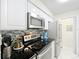 Updated kitchen featuring white cabinets, stainless steel appliances, and mosaic backsplash for a modern touch at 232 Afton Sq # 201, Altamonte Springs, FL 32714