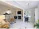 Bright living room featuring tile flooring, modern fireplace, and an adjacent kitchen for open-concept living at 232 Afton Sq # 201, Altamonte Springs, FL 32714