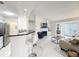 Open-concept living area with a kitchen, bar seating, and cozy fireplace at 232 Afton Sq # 201, Altamonte Springs, FL 32714