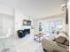 Bright living room features a fireplace, TV, couch, and lots of natural light at 232 Afton Sq # 201, Altamonte Springs, FL 32714