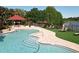 A sparkling pool offers a refreshing escape with comfortable loungers and a gazebo overlooking the tranquil lake at 232 Afton Sq # 201, Altamonte Springs, FL 32714