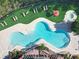 Aerial view of the free-form swimming pool with lounge chairs and manicured landscaping at 232 Afton Sq # 201, Altamonte Springs, FL 32714