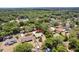 Aerial view of the home nestled among mature trees in a quiet neighborhood at 255 Katrina St, De Leon Springs, FL 32130