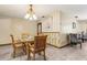 Warm dining room with glass-top table, wood chairs, and decorative wall accents at 255 Katrina St, De Leon Springs, FL 32130
