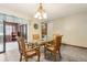 Inviting dining room featuring a glass-top table, wooden chairs, and stylish chandelier at 255 Katrina St, De Leon Springs, FL 32130