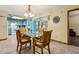 Dining room with glass table, wooden chairs, open to kitchen and sunroom, ideal for entertaining at 255 Katrina St, De Leon Springs, FL 32130